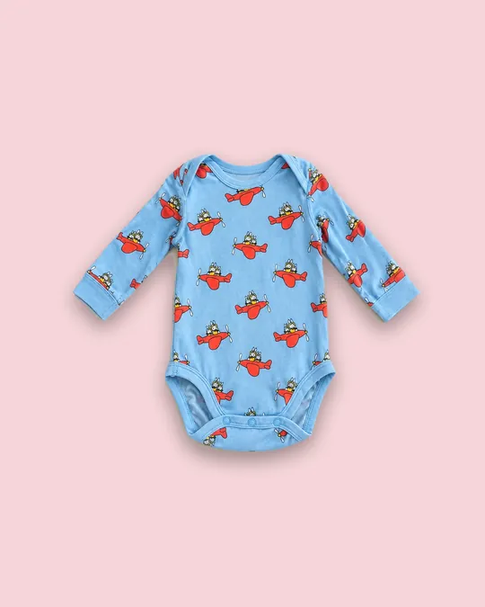 Body à motif d'avions sur fond fond uni rose